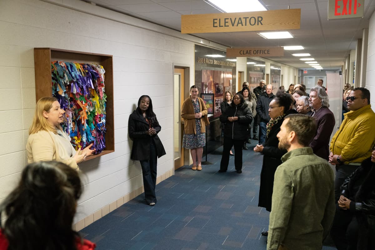 Group of people gathered in Briggs Building during the Healing Wall Panel 5 unveiling