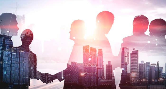 Decorative image showing business people silhouette with cityscape reflection