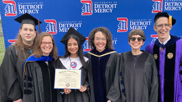Detroit Mercy Class of 2021 Valedictorian Nurzahan Rahman, English and education major, stands with some of her professors at Detroit Mercy's on campus celebration event